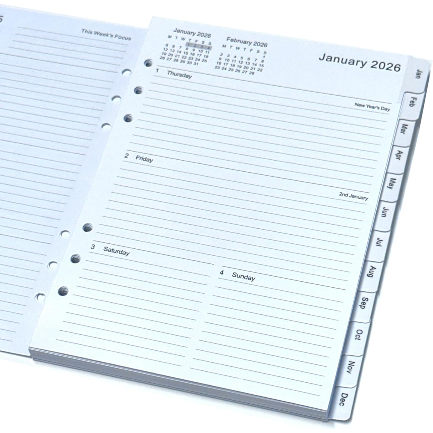 An open spiral-bound planner or calendar organizer showing January 2026, with lined daily sections, a small monthly calendar at the top, and MONTH page tabs along the right edge.