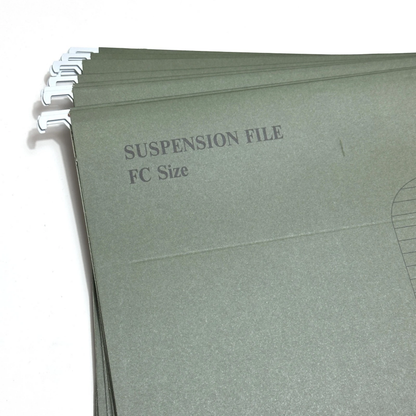 A stack of muted sage green paper suspension file folders with metal binder tabs on the left edge, printed with the text 'SUSPENSION FILE FC Size' on a white background.