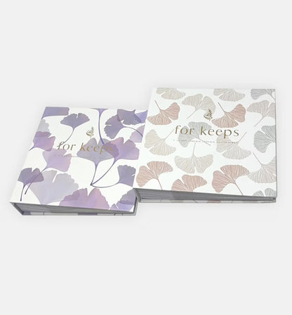 Two floral-patterned photo albums with 'for keeps' text , two colours , purple and pink cover choices