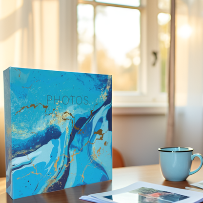 Blue marbled photo album on a table with a cup in the background