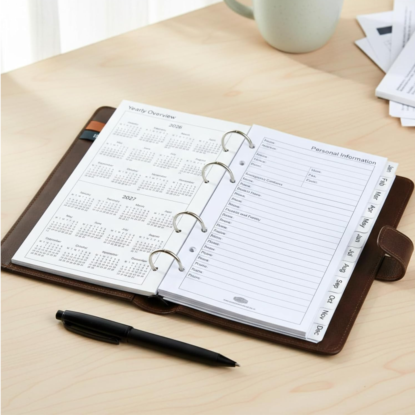 Weekly planner with personal information section on a desk with a pen and coffee cup.