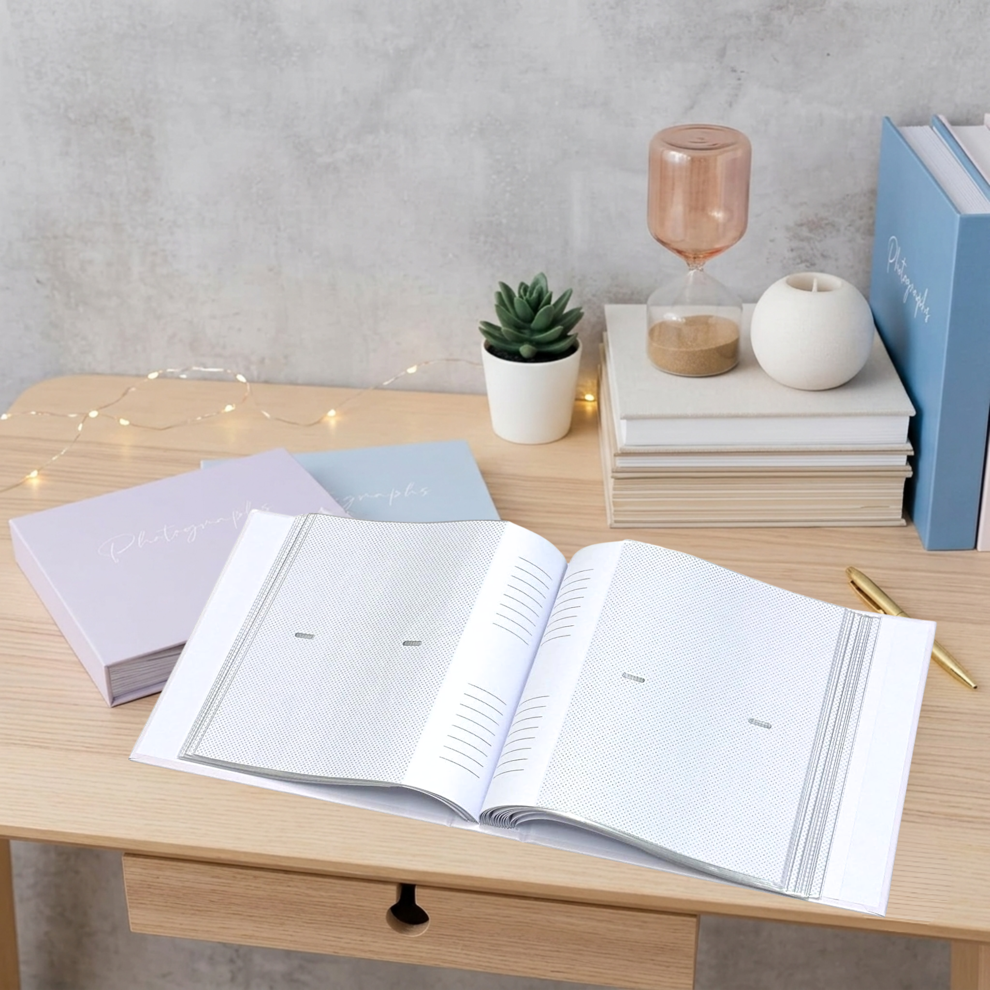 PASTEL BLUE AND PURPLE PHOTOBOOKS LYING ON TABLE ONE PHOTO ALBUM OPEN TO SHOW INNER SLIP IN POCKETS AND MEMO AREA